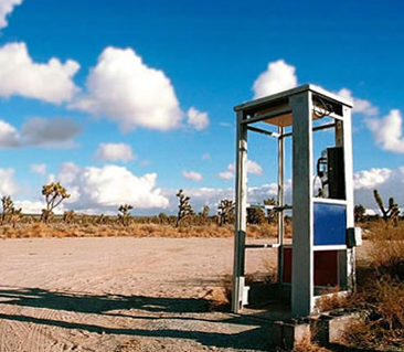 title Photo of a pay phone in the desert